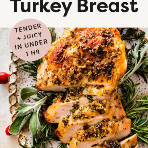 Air Fryer Turkey Breast on a platter garnished with herbs and cranberries.