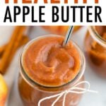 Glass jar filled with apple butter and decorated with a twine bow.