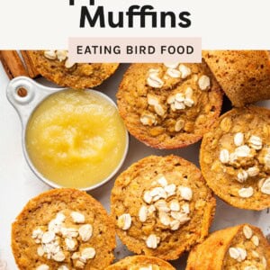 Overhead view of oat-topped applesauce muffins with a small bowl of applesauce in the center, labeled “Healthy Applesauce Muffins.”