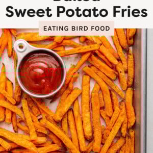 Sweet potato fries on a sheet pan and served with ketchup.