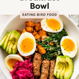 Breakfast Bowl made with greens, sweet potato, eggs, sauerkraut and avocado.