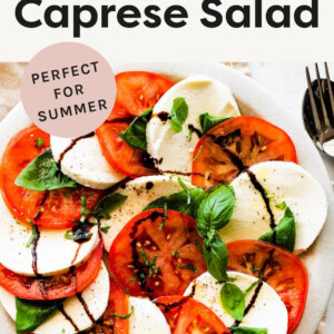 Caprese salad on a plate drizzles with balsamic.