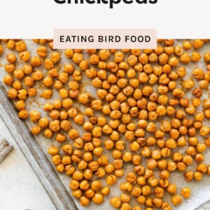A baking sheet filled with golden roasted chickpeas labeled “Easy Roasted Chickpeas” from Eating Bird Food.