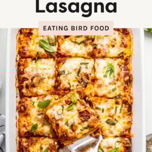 Lasagna in a casserole dish cut into squares. A spatula is lifting a piece out of the pan.