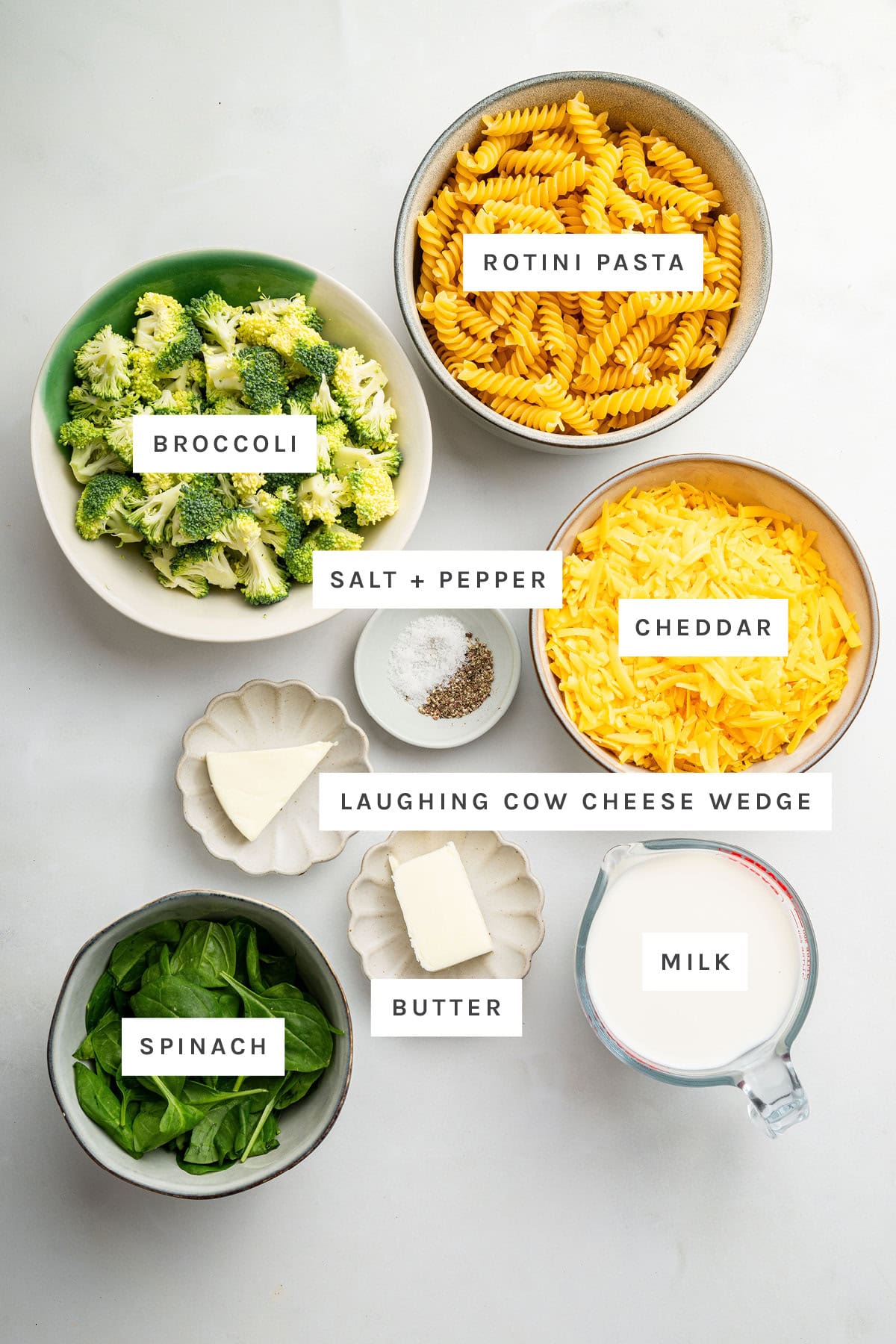 Ingredients for the healthy mac and cheese: rotini pasta, broccoli, cheddar cheese, milk, spinach, salt, pepper, butter and laughing cow cheese wedge.