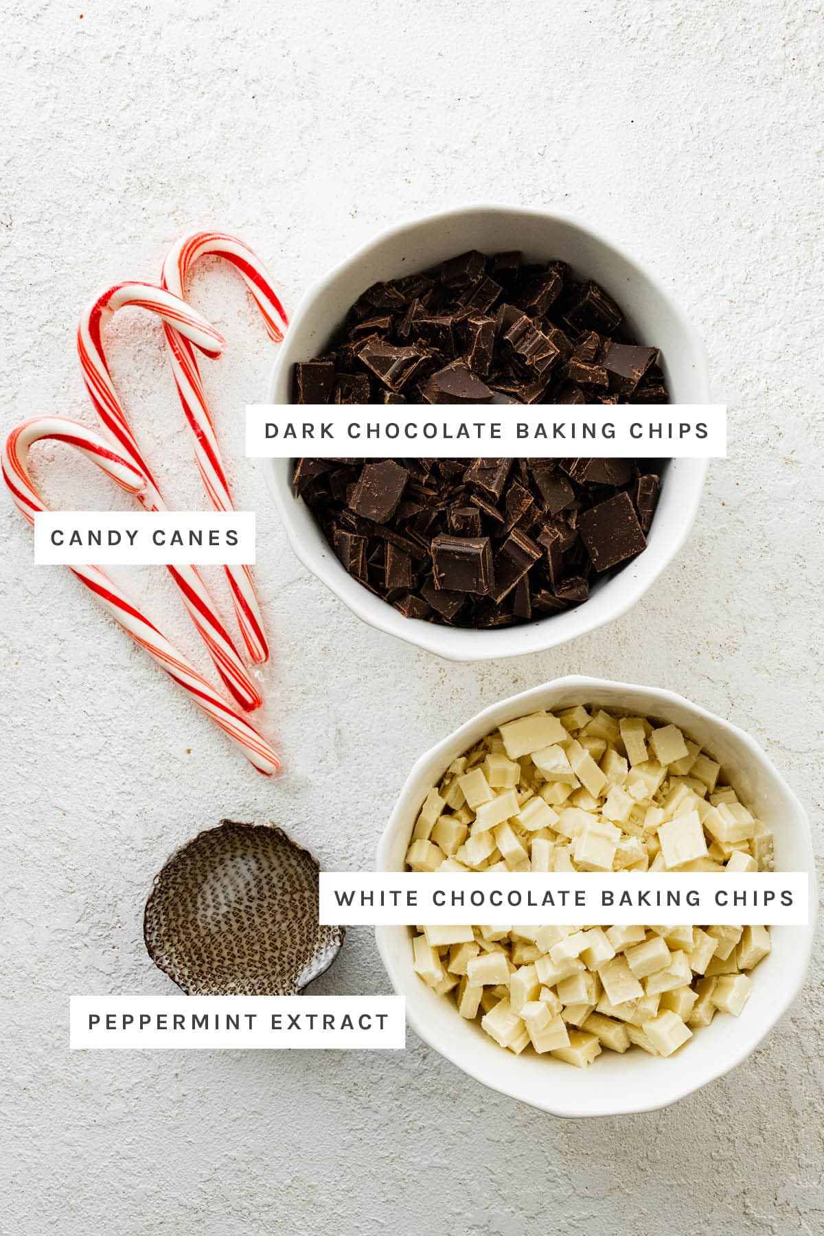 Ingredients measured out to make Peppermint Bark: candy canes, dark chocolate baking chips, white chocolate baking chips, peppermint extract.