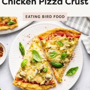 Two slices of chicken-crust pizza topped with melted cheese, vegetables, and fresh basil on a white plate.