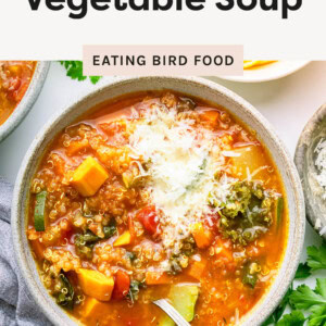 Photo of quinoa vegetable soup in a bowl topped with cheese.