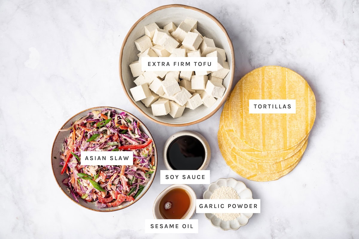Asian Tofu Tacos ingredients: Extra firm tofu, tortillas, Asian slaw, soy sauce, garlic powder, sesame oil.