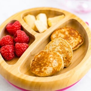 Baby plate with mini pancakes, raspberries and banana.