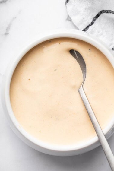 Homemade Big Mac sauce in a white bowl with a silver spoon.