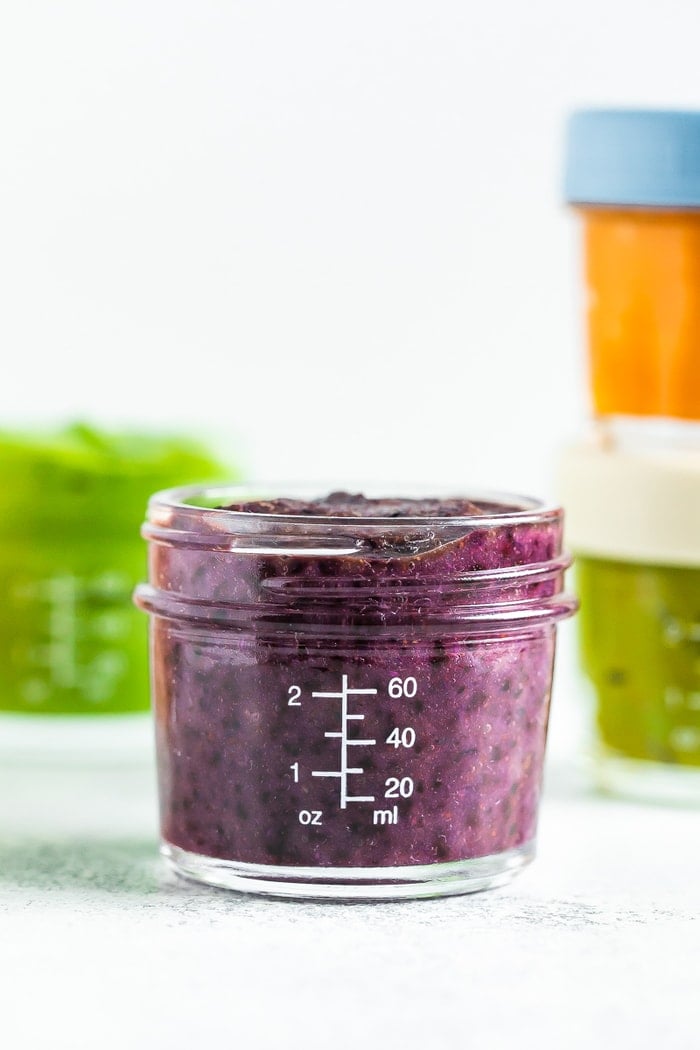 Blueberry banana quinoa flax baby food in a 4 oz baby food jar.