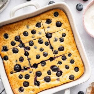 Blueberry cottage cheese breakfast bake cut into squares in a white baking dish.
