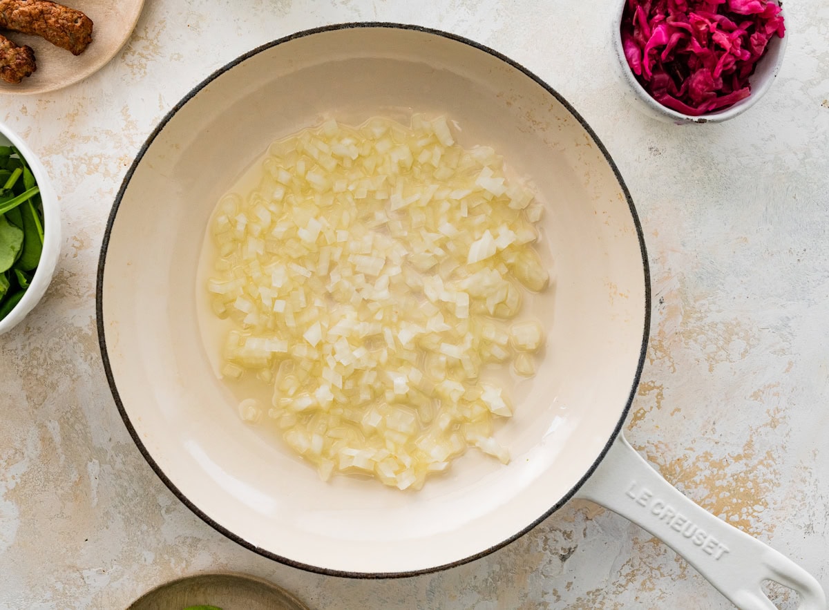 Sautéed onions cooking in a skillet.