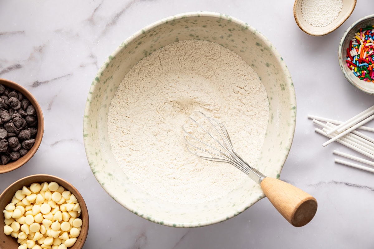 Dry ingredients whisked together in a mixing bowl for cake pop batter.