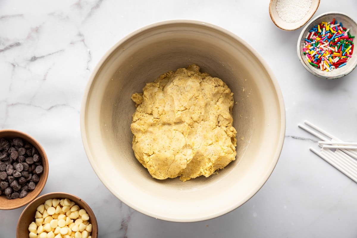 Bowl of cake mixture made with crumbled cake and Greek yogurt before rolling.