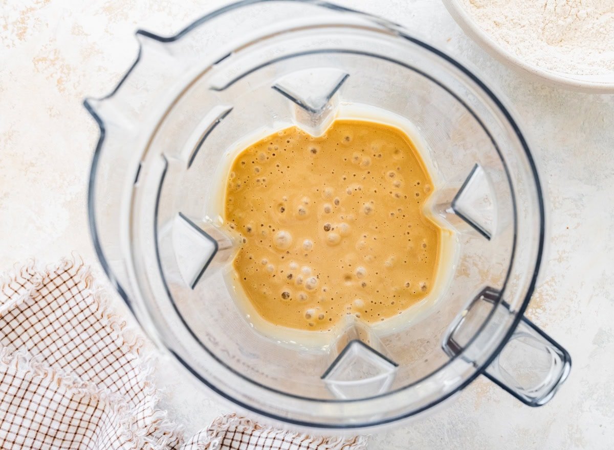 Blender with wet banana bread batter mixture inside.