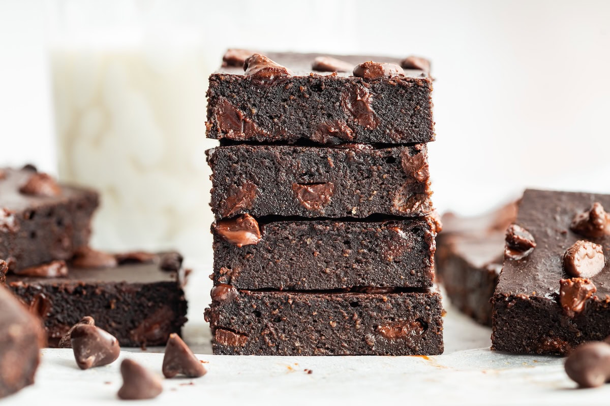Stack of fudgy cottage cheese protein brownies showing moist texture.
