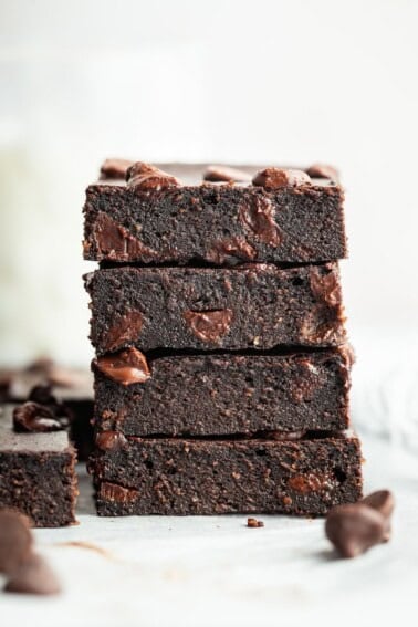 Stack of four cottage cheese brownies showing moist texture.