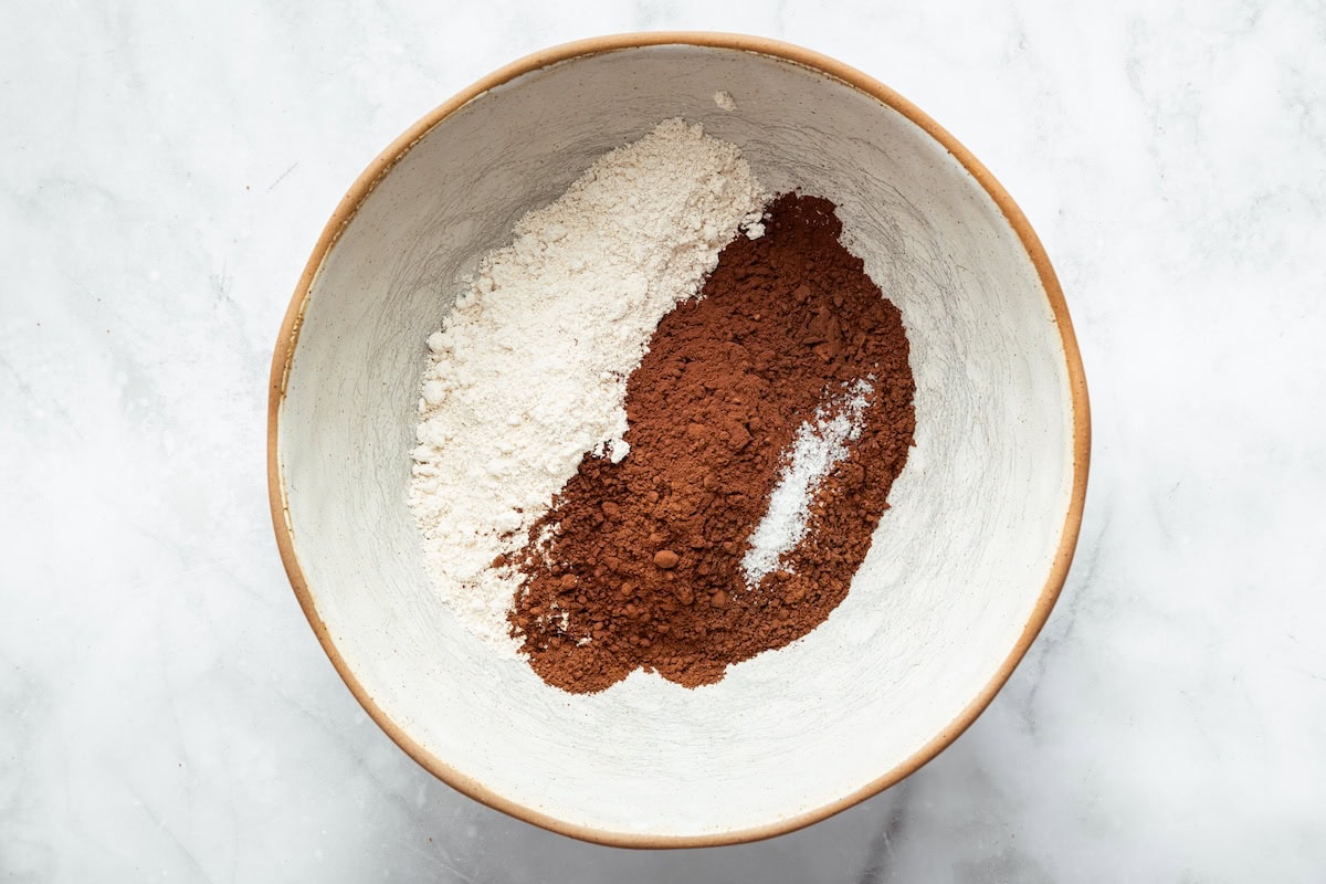 Bowl with cocoa powder and oat flour for brownies with cottage cheese.