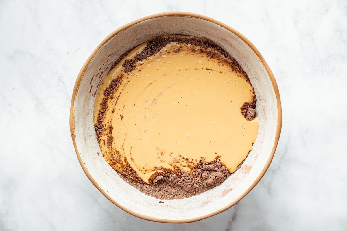 Mixing wet and dry ingredients together to make cottage cheese protein brownies.