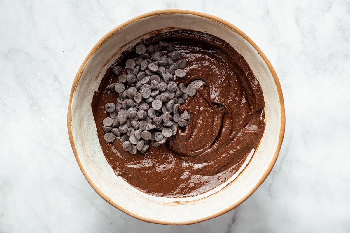 Mixing bowl filled with rich chocolate batter for brownies with cottage cheese.