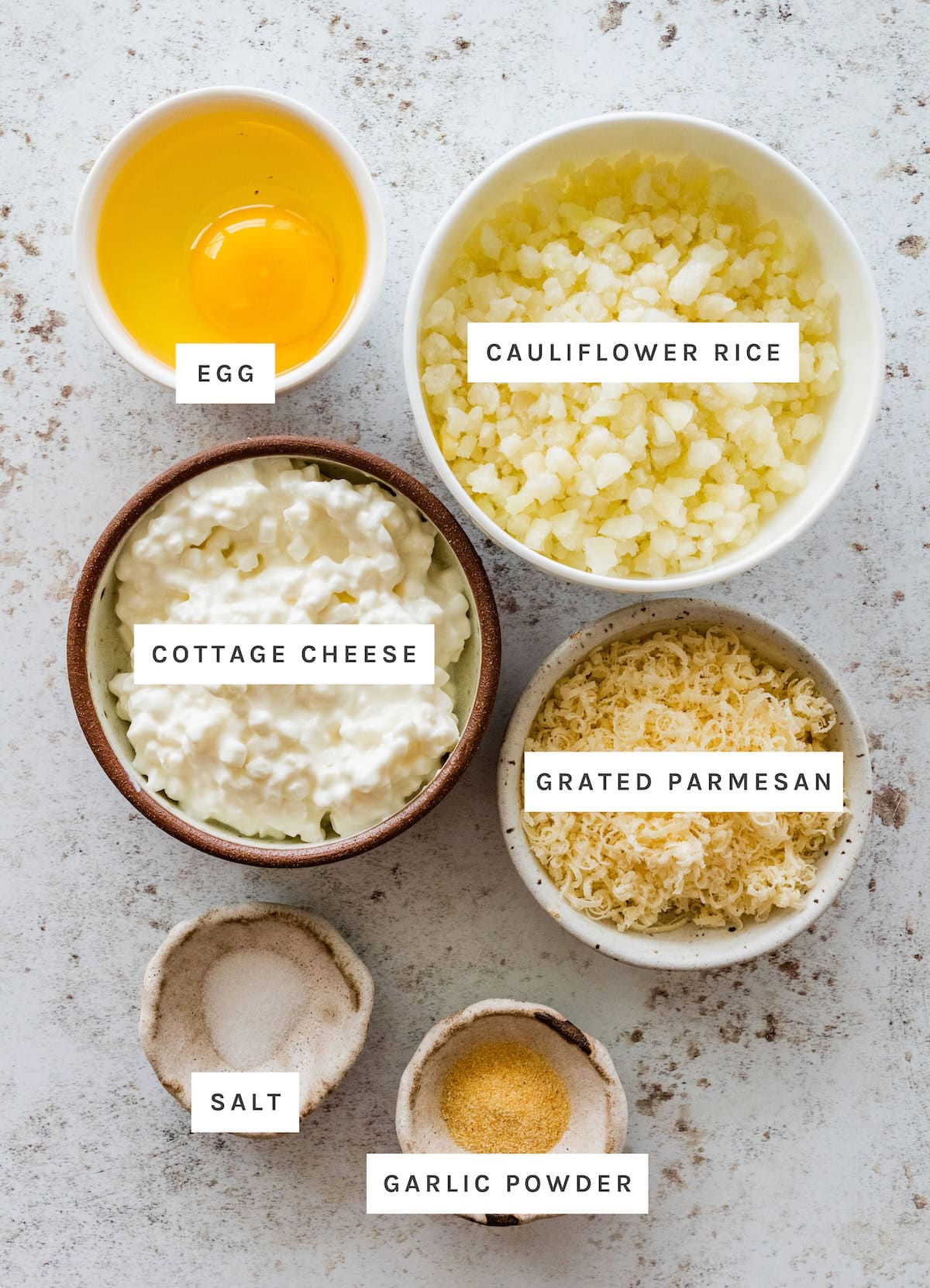 Cottage Cheese Cauliflower Thins ingredients: Egg, cauliflower rice, cottage cheese, grated parmesan, salt, garlic powder.