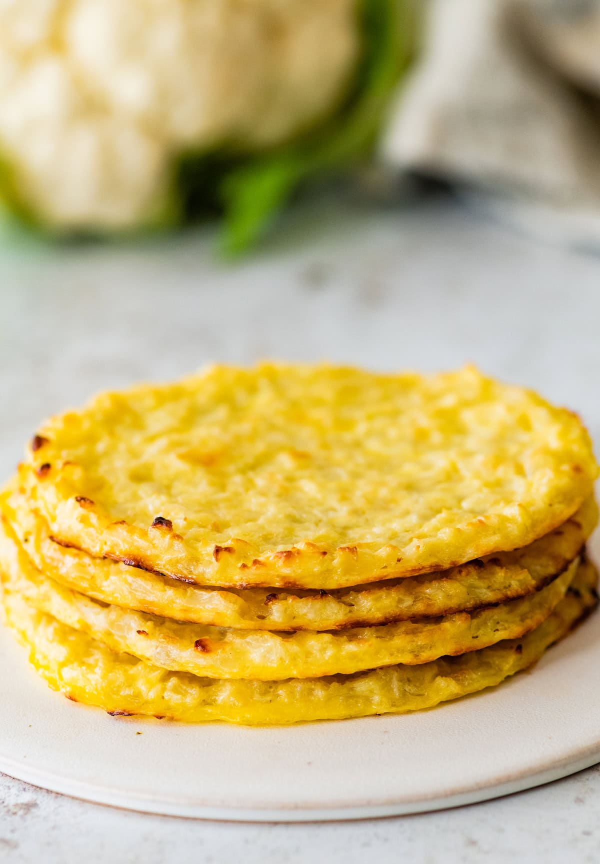 Four cauliflower thins stacked on top of each other.