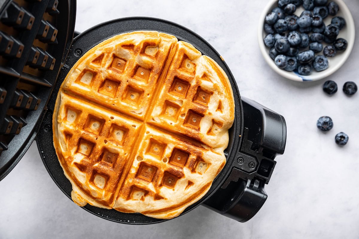 Freshly cooked waffle inside a waffle maker.