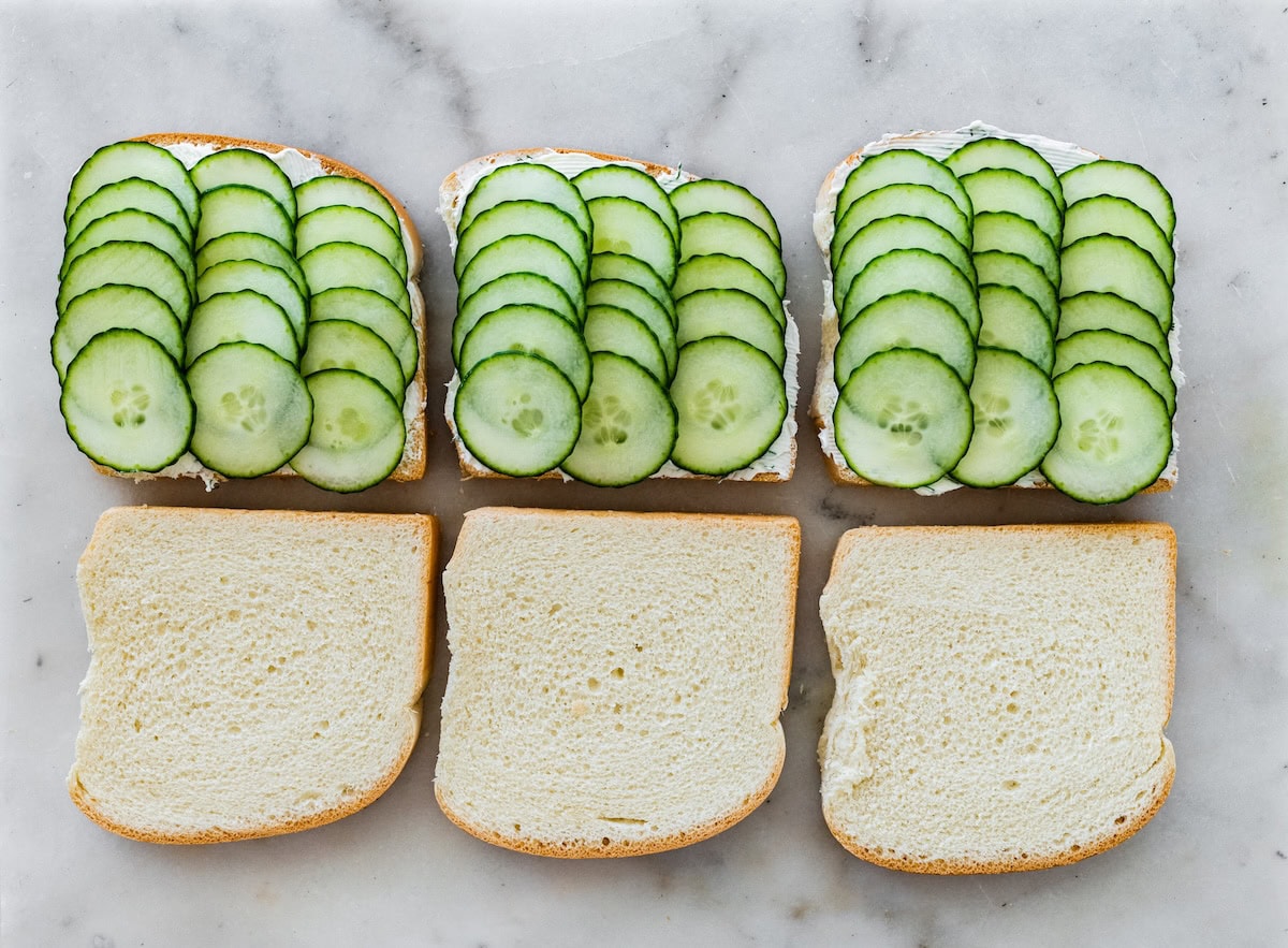 Open-faced cucumber sandwiches with rows of thinly sliced cucumber on soft white bread.