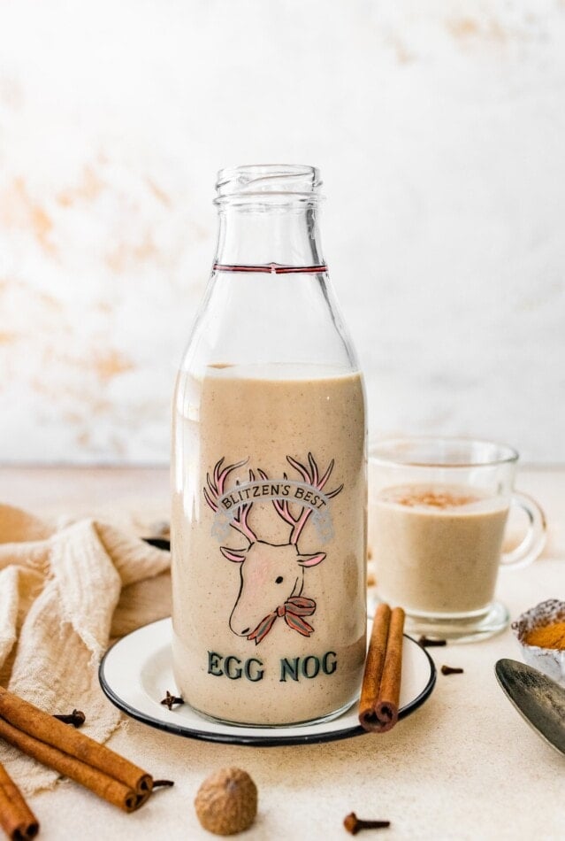 A jug and a glass of dairy free eggnog.