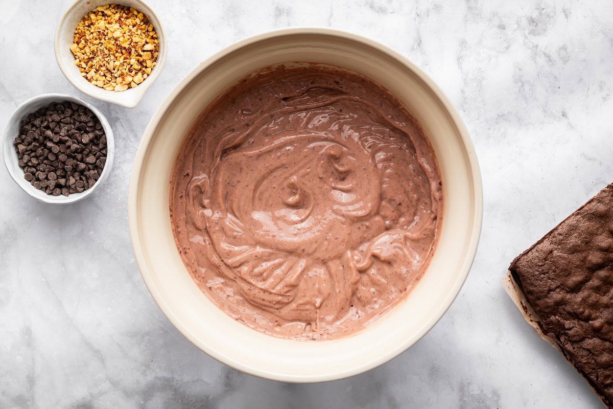 Chocolate pudding mixture in a mixing bowl ready to be layered in the trifle.