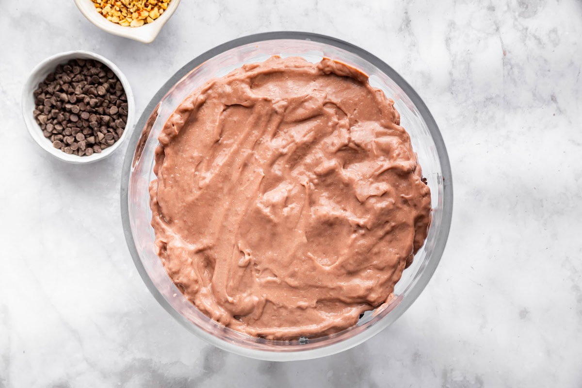 Smooth chocolate pudding layer spread evenly in the trifle dish during assembly.