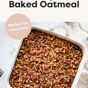 Baked oatmeal topped with chopped nuts in a white square baking dish.