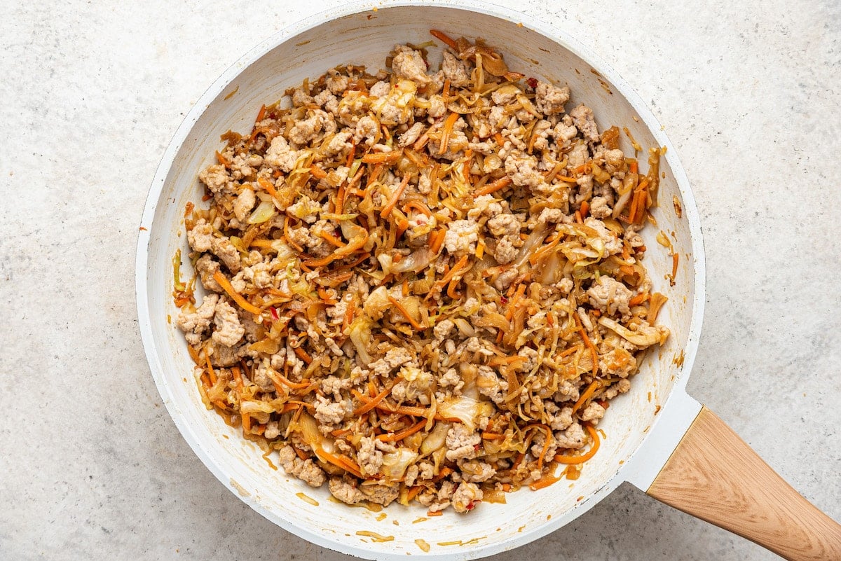 Egg roll in a bowl in a sauté pan after cooking.