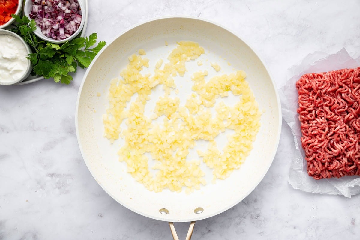 Sautéed onion and garlic in a skillet.