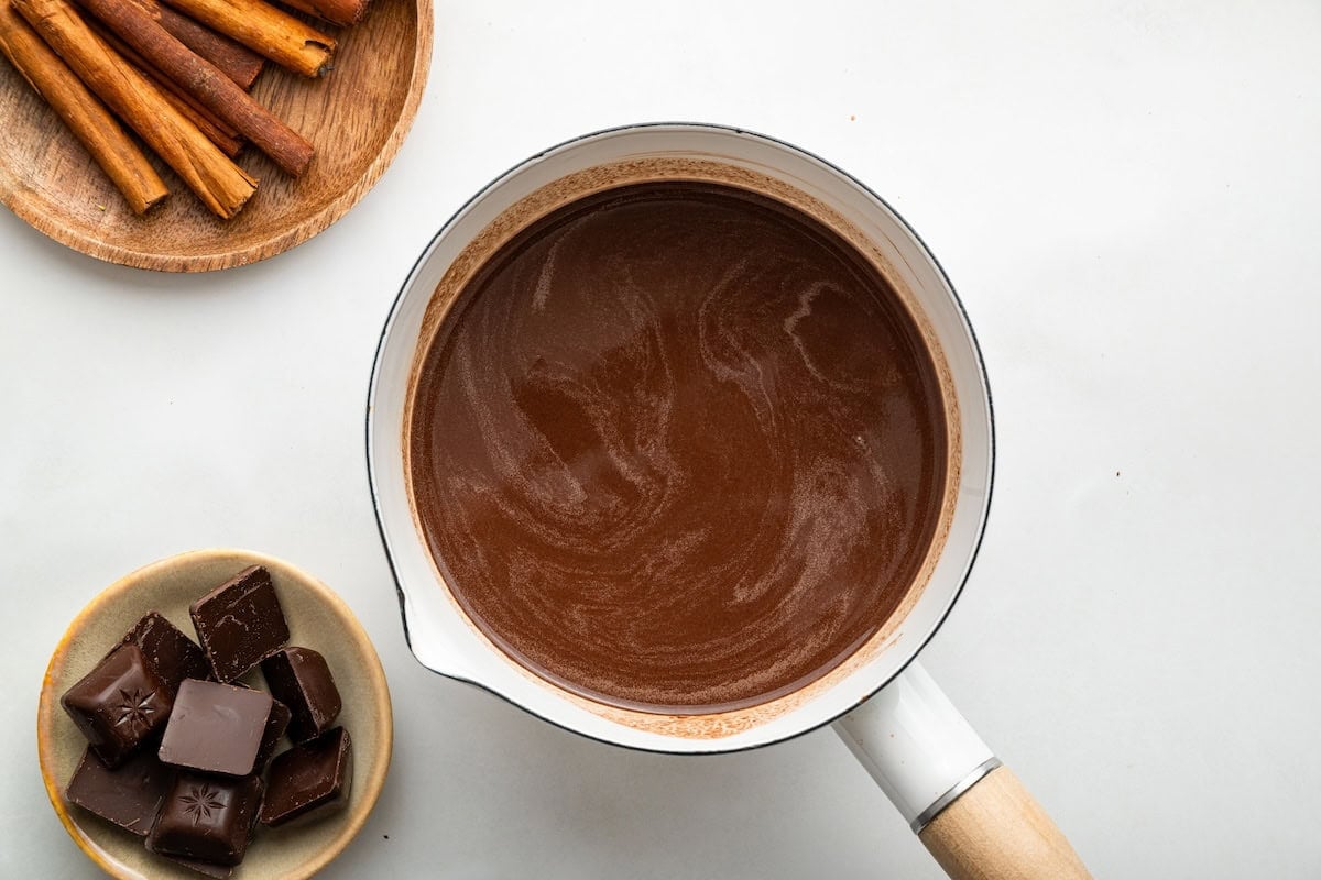 Mixed together hot chocolate in a small white saucepan.