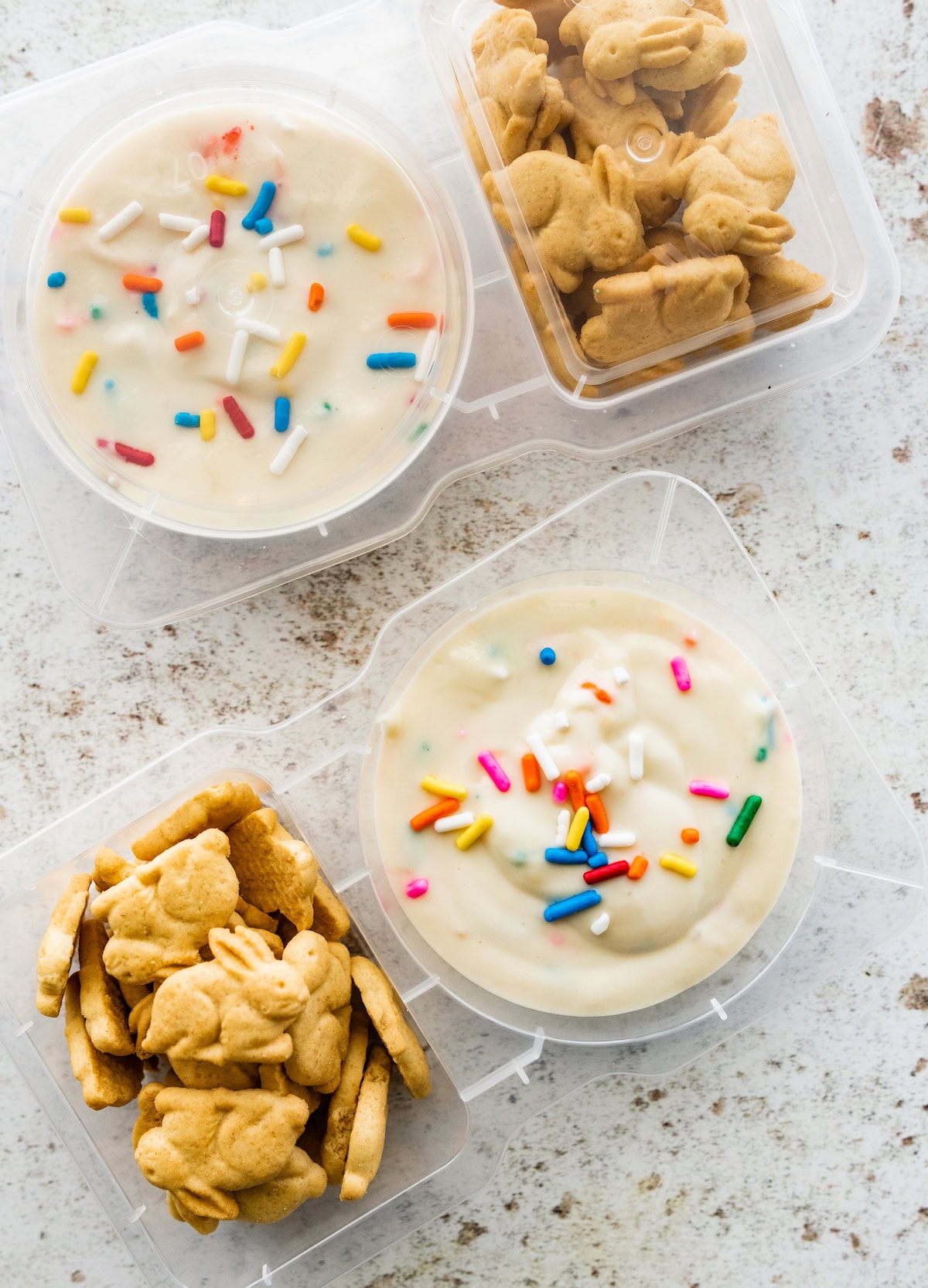 Two small containers with a yogurt based dunkaroo dip and bunny crackers.