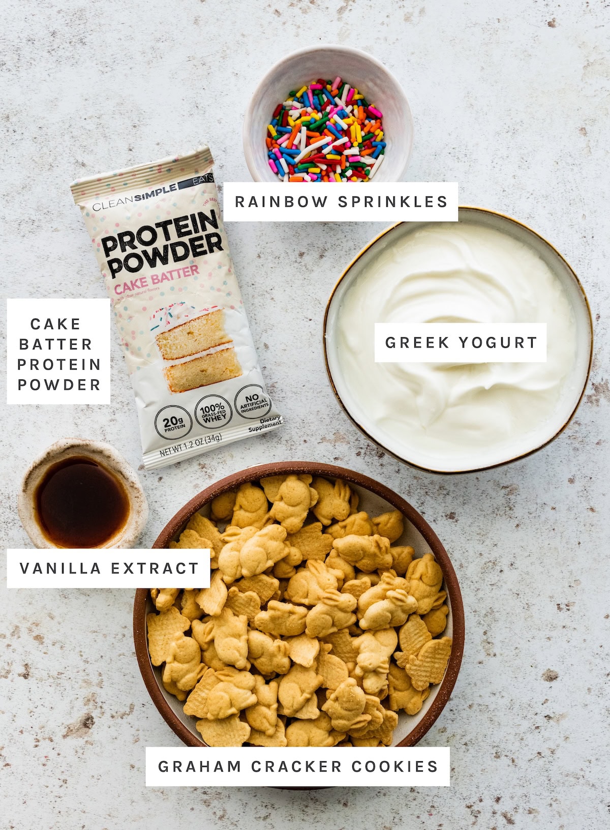 Ingredients for High Protein Dunkaroo Dip: Cake batter protein powder, Greek yogurt, rainbow sprinkles, vanilla extract, graham cracker cookies.