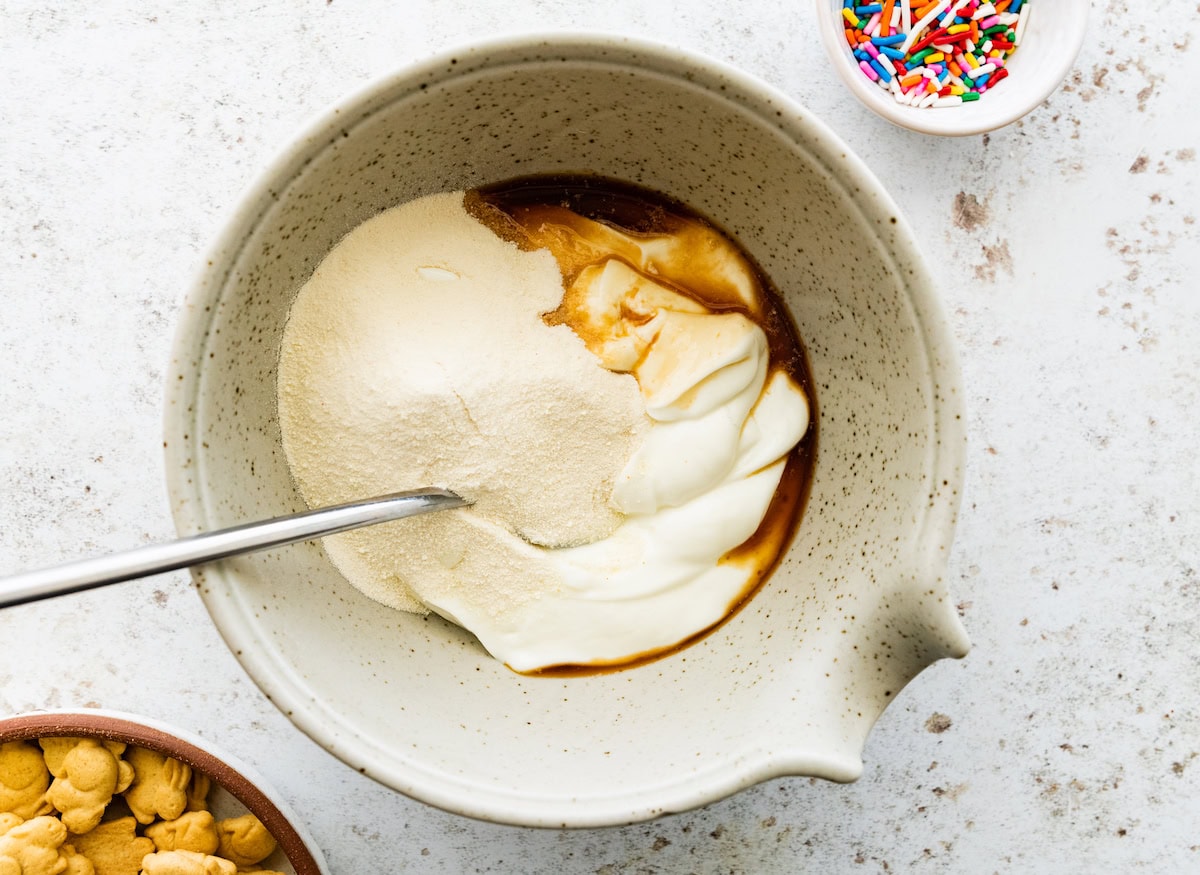 A large mixing bowl of Greek yogurt, protein powder, and vanilla.