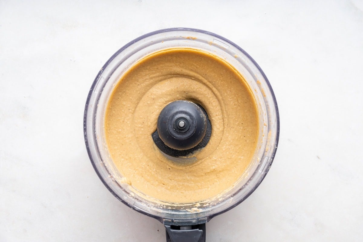 A blended hummus in a food processor.