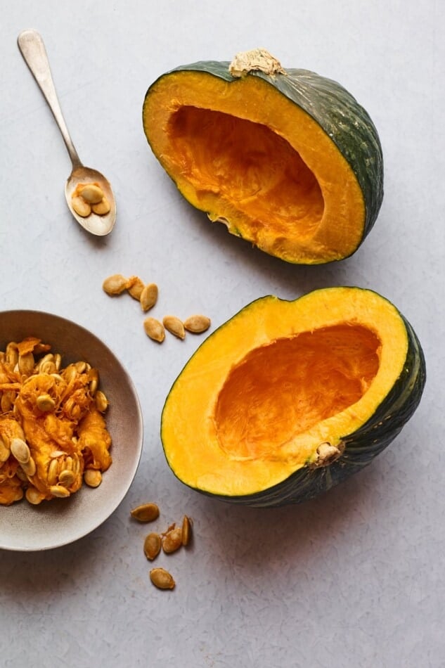 A Kabocha squash cut in half with the seeds removed and in a bowl.