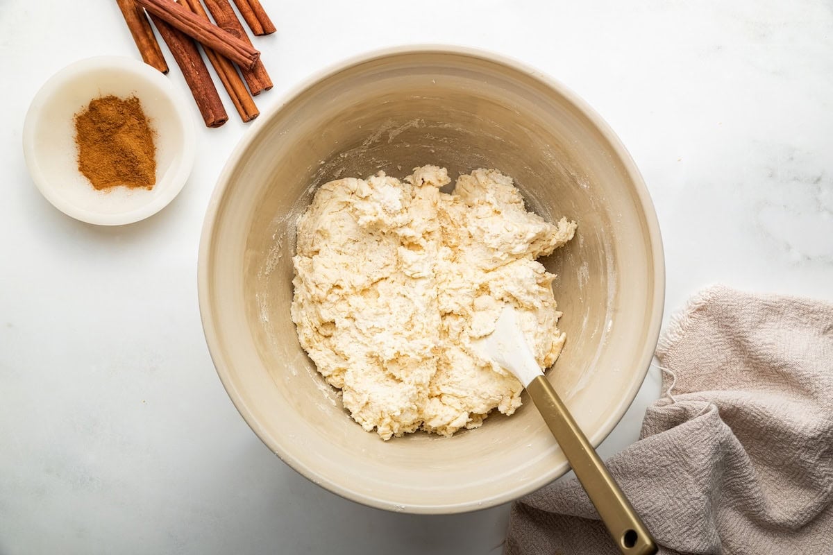A large mixing bowl of protein cinnamon rolls dough.