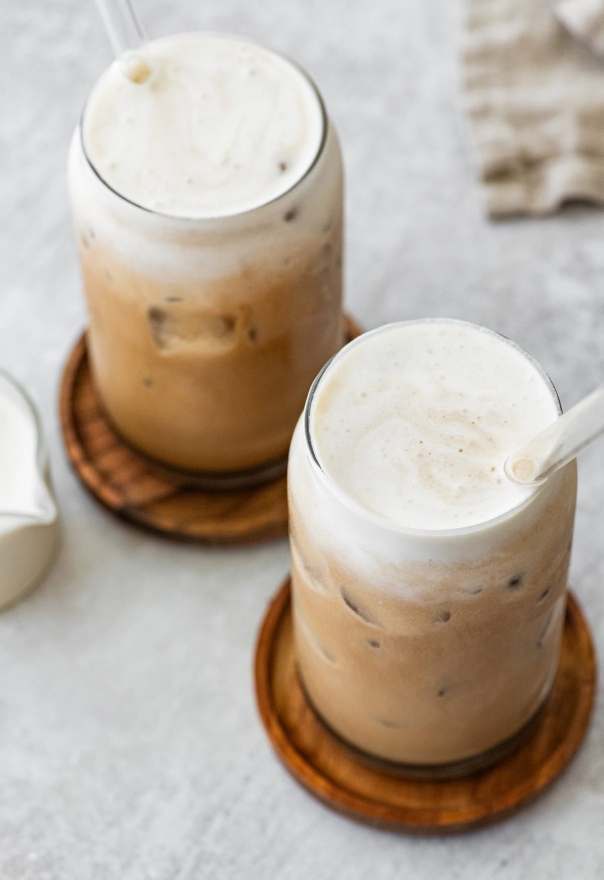 Thick layer of creamy protein cold foam on top of iced coffee.