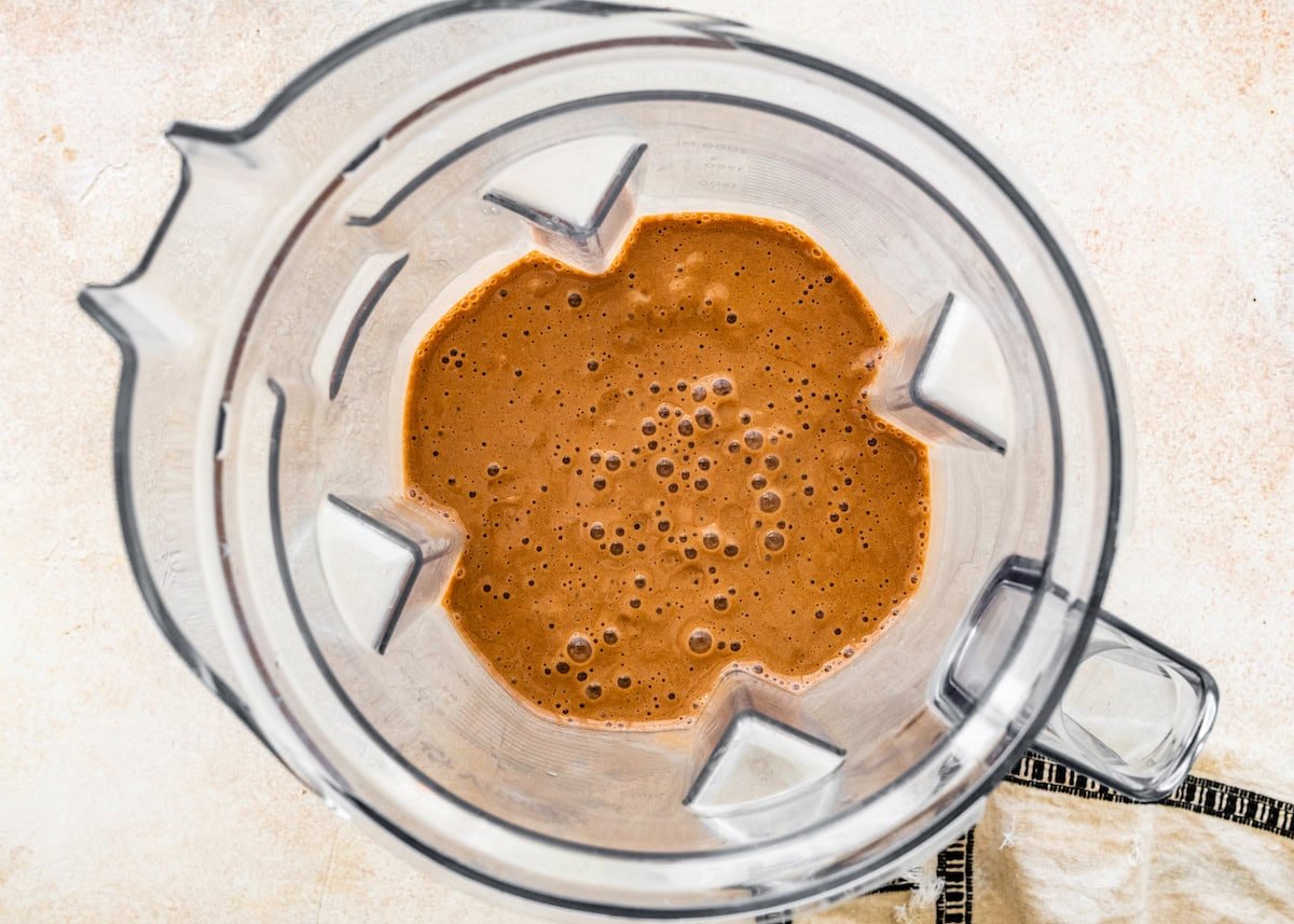 The blended protein hot chocolate in the base of a Vitamix blender.
