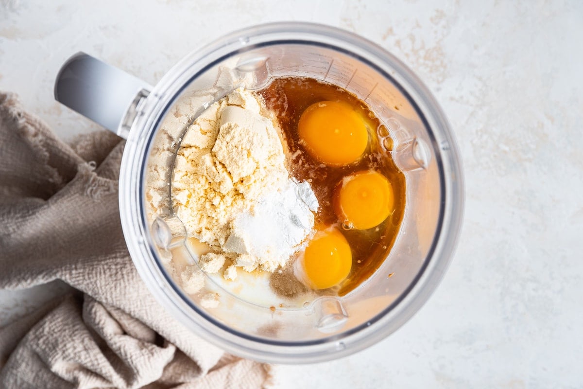Banana, eggs, maple syrup, almond butter, almond milk, vanilla extract, vanilla protein powder, baking powder and sea salt in a high powered blender.