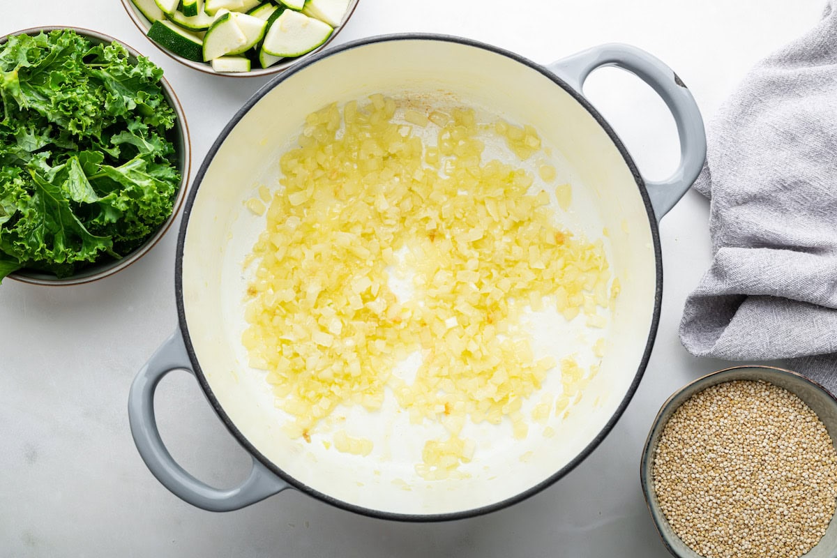 A large pot of sauteed, diced, white onions.
