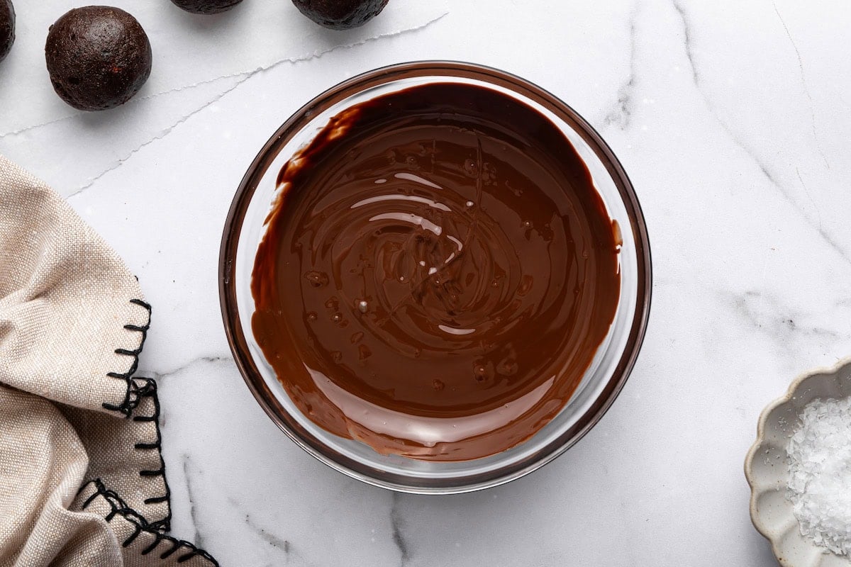Bowl of melted chocolate ready for dipping protein balls.
