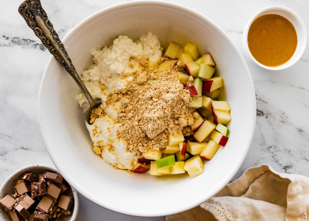 Chopped apples, cottage cheese, greek yogurt and powdered peanut butter in a mixing bowl together.