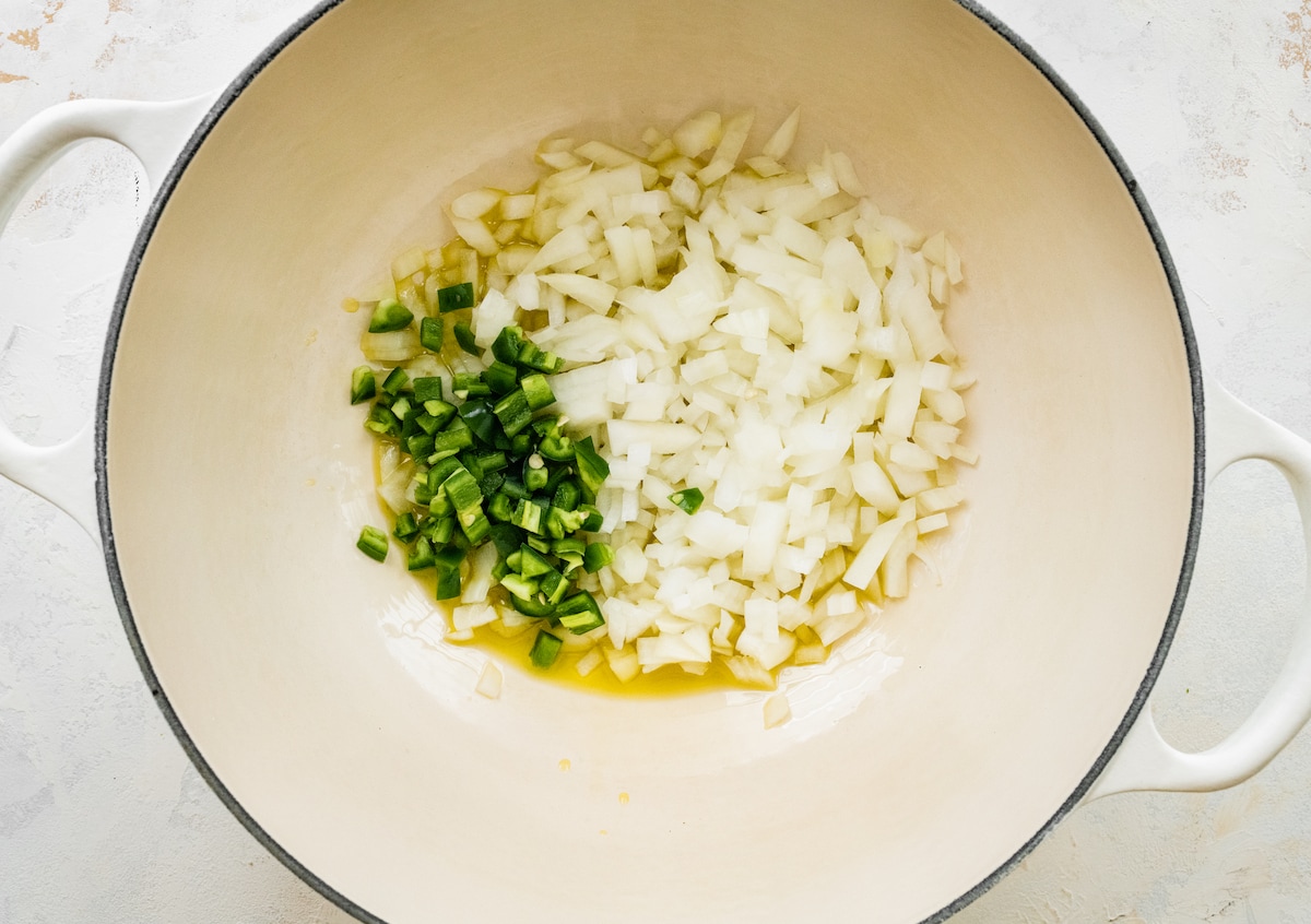 Onions and jalapeños in a sauce pan.